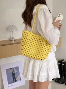 Détail de sac cabas tissé jaune, élégante présentation de sac à main souple de vacances.