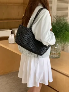 Black woven leather shoulder bag, chic hollow design for summer vacation daily commuting.