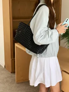Black woven shoulder bag detail, stylish woven underarm tote bag for daily fashion.