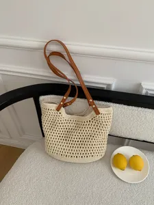 Handmade woven straw tote bag with brown leather straps, perfect for beach vacation and daily use.