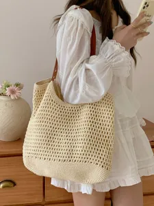 Beige handmade woven tote bag for women, large capacity straw shoulder bag for beach trip.