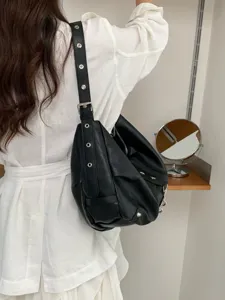 Casual retro soft leather shoulder bag with metal grommets, stylish large capacity commuter hobo.