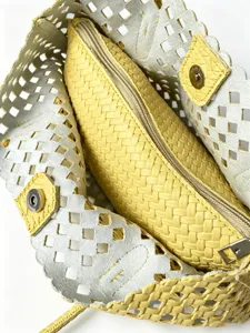 Close-up detail of the hollow woven shoulder bag and inner pouch with fine texture.