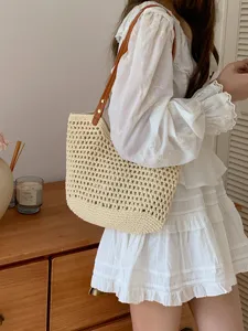 Beige woven straw tote bag for women, stylish single shoulder handbag for beach vacation.