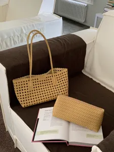 Summer resort woven hollow shoulder tote bag and matching pouch set for women casual use.