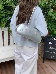 Silver metallic shoulder bag, trendy ballet style bowling bag design for spring daily wear.