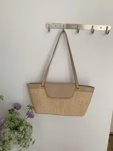 French vintage straw woven shoulder bag detail showcase with elegant leather flap design.