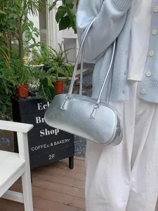 Stylish silver metallic shoulder bag for women, trendy Korean style baguette purse daily wear.