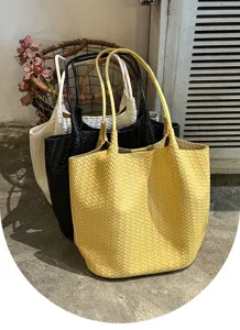 Detailed shot of woven tote bags in yellow, black and white, showing large capacity and design.