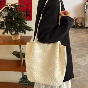 Detailed view of white woven tote bag, chic shoulder bag for women, stylish daily commute accessory.