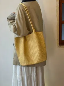 Stylish yellow woven leather tote bag for women, large capacity shoulder commuting bag.