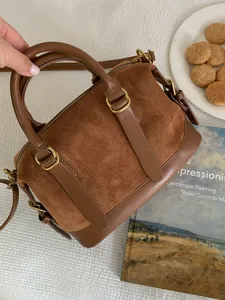 Brown suede bowling bag, retro leather handbag, versatile crossbody bag for women detail.