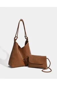 Woven tote bag detail showing the texture and structured shape of the brown leather purse.