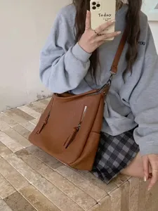 Retro brown hobo shoulder bag for women, versatile PU leather crossbody tote with zippers.