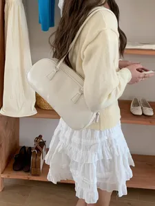 Minimalist white shoulder bag for women, chic PU leather underarm handbag for daily commuting.