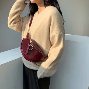 Wine red half-moon crossbody chest bag, stylish leather waist bag with metal chain strap.