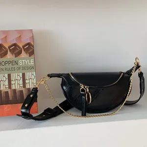 Black crescent waist bag for women, stylish crossbody bag with gold chain and sleek design.