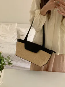 Detailed view of French vintage straw woven shoulder tote bag with black leather trim, chic summer.