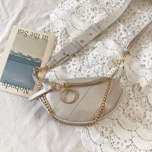 Stylish grey chest waist bag for women, chic crossbody bag with trendy gold chain and ring.