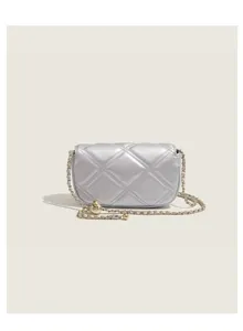 Silver quilted chain bag detail view, showing exquisite diamond stitching and gold ball.