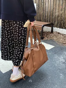 Stylish brown PU leather travel tote bag, large capacity shoulder bag for daily use.