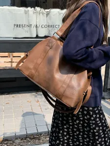 Brown leather travel bag large capacity shoulder crossbody tote bag lifestyle detail shot