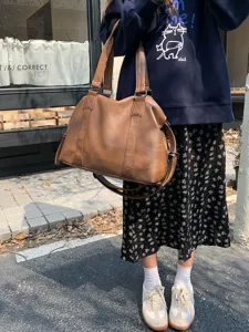 Large capacity brown PU leather travel bag, versatile tote and shoulder bag for women.