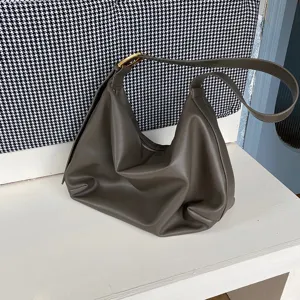 Soft slouchy shoulder bag detail showing premium leather texture and curved hobo shape design.