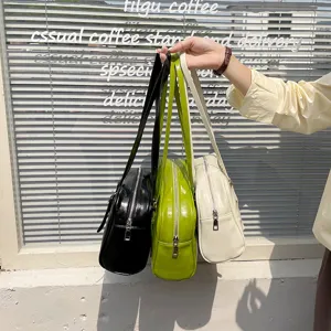 Detail view of fashionable PU leather shoulder bags in black, green, and white colors.