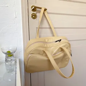 Detail view of butter yellow shoulder tote bag showing large capacity and zipper design.