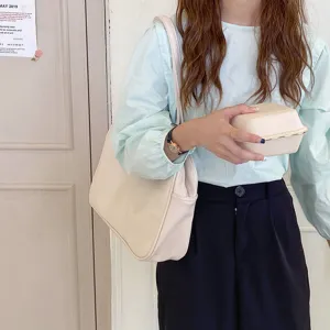 Minimalist beige shoulder bag for women, casual tote handbag with versatile design.