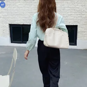 Minimalist cream leather shoulder bag for women, stylish underarm handbag daily use.