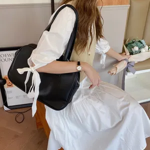 Stylish black leather shoulder bag for women, large capacity minimalist underarm tote.