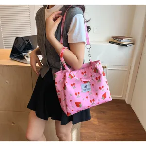 Cute pink strawberry print tote bag detail view, casual canvas shoulder bag for women.
