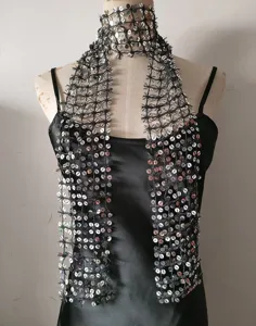 Close-up view of a sparkly sequinned mesh scarf accessory, detailed texture and shimmering design.
