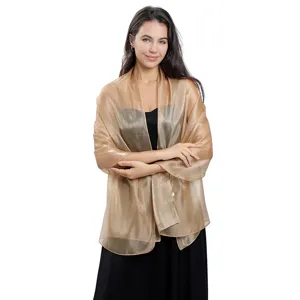 Exquisite sheer gold organza shawl detail, elegant evening party and bridal accessory.