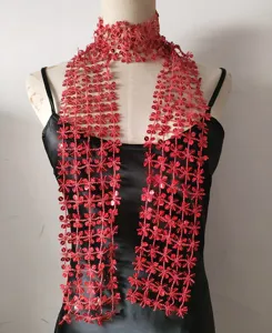 Red sequin mesh scarf detail, sparkly floral trim close-up, fashion accessory display.