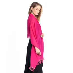Detailed view of a vibrant magenta chiffon shawl with delicate tassel hem for elegant style.