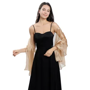 Gold sheer organza shawl detail, lightweight shimmering fabric, elegant party wear accessory.