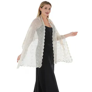 Close-up of exquisite sequin floral lace shawl, elegant evening dress wrap accessory.