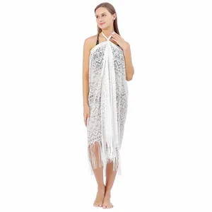 White lace beach cover-up detail, featuring hollow-out geometric patterns and stylish fringe hem.