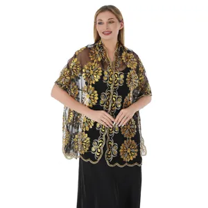 Close-up shot of the elegant black sheer shawl featuring stunning gold sequin floral embroidery.