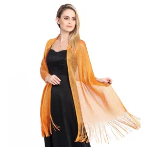 Detailed view of shimmering metallic fringe evening shawl, elegant party wrap accessory.
