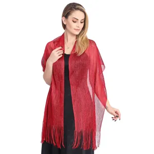 Shimmery metallic evening wrap detail, elegant red tassel fringe fabric texture view.