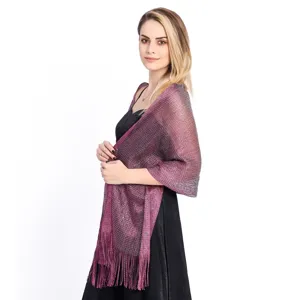 Detail view of glittering metallic shawl with fringe, ideal for evening parties and bridal wear.