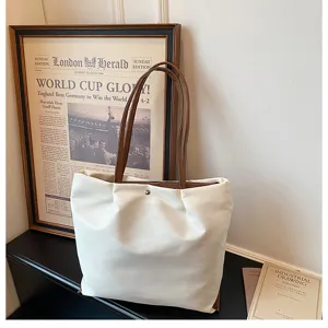 Casual oxford cloth tote bag detail showing large capacity design and premium brown straps.