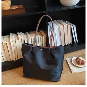 Casual black nylon tote bag detail view, large capacity shoulder bag with brown handles.