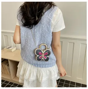 Chic butterfly cross-body bag detail shot, sparkling rhinestone design with chain strap.