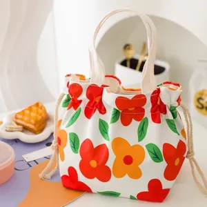 Sac bento mignon en toile avec cordon et imprimé floral, cabas portable pour travail et école.