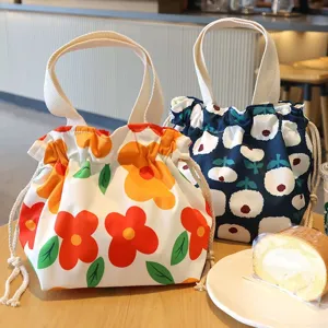 Canvas drawstring lunch bag detail view, cute floral print pattern, portable everyday tote style.